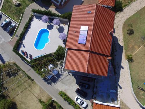an overhead view of a large house with a red roof at Guesthouse Marija in Lopar