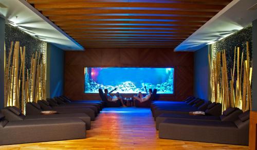 a living room with couches and a large aquarium at Ramada Plaza Antalya in Antalya
