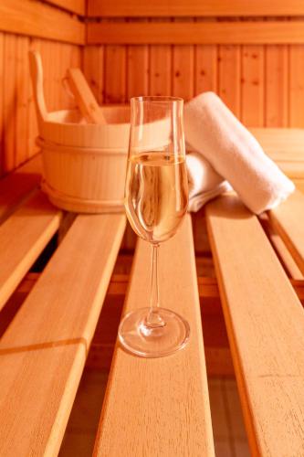 a glass of wine sitting on a table at Berghotel Drei Brüder Höhe in Marienberg
