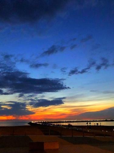 a view of a beach at sunset with a pier at Maison Rebelle in Ostend