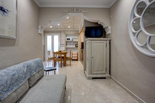 a living room with a couch and a dining room at Hotel Rosa in Denia