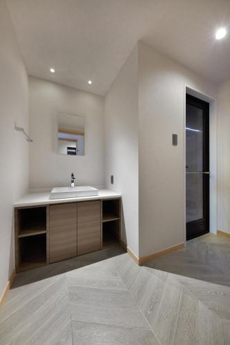 a bathroom with a sink and a large window at THIRD ishigakijima in Ishigaki Island