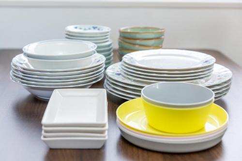 a pile of plates and bowls on a table at KOSHIGOE seaside inn in Kamakura