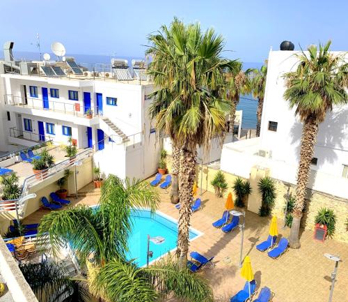 an aerial view of a hotel with palm trees and a pool at Kassavetis Center - Hotel Studios & Apartments in Hersonissos