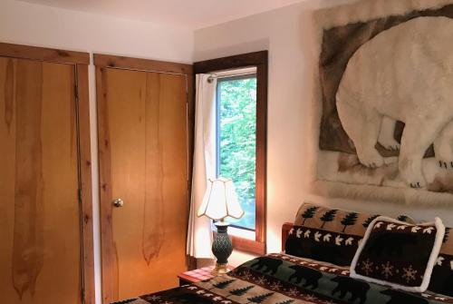 a bedroom with a couch and an elephant picture on the wall at Mountain Breeze Getaway Condos in Warren