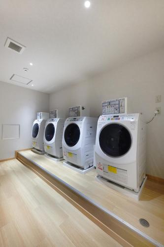 a row of washing machines on display in a room at THIRD ishigakijima in Ishigaki Island