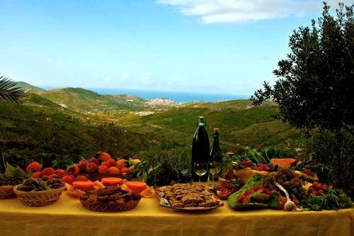a table with a bunch of food and bottles of wine at Villa Nigro in Laureana Cilento