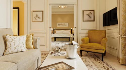 a living room with a couch and a bed at Shangri-La Paris in Paris