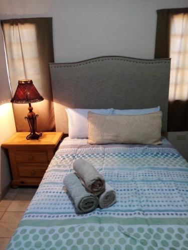 a bedroom with a bed with towels on it at Canela Apartment, Pet friendly in Puerto Peñasco