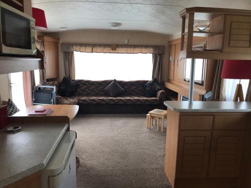 an rv kitchen and living room with a couch at Golden Sands Ingoldmells (Atlantis) in Skegness