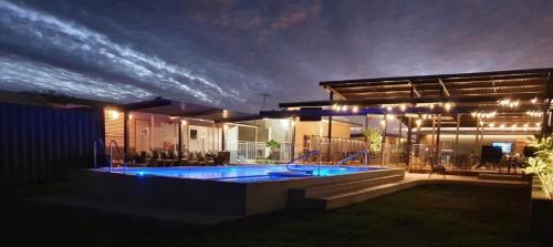 a house with a swimming pool at night at Oasis Newman in Newman