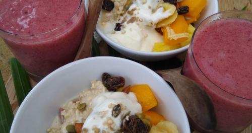 a table with two plates of food and two smoothies at Ikurangi Eco Retreat in Rarotonga