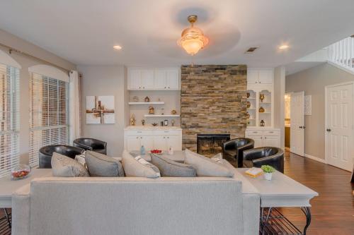 a living room with a couch and a fireplace at Frisco finest home, large, pool, no parties! in Frisco