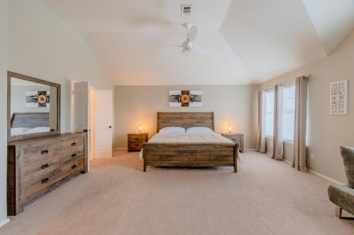 a bedroom with a bed and a dresser and a mirror at Frisco finest home, large, pool, no parties! in Frisco