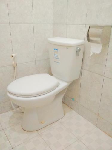 a bathroom with a white toilet in a room at Wisma Andany in Jepara