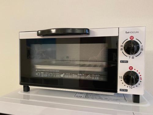a microwave oven sitting on top of a counter at Clomtown ishigaki in Ishigaki Island