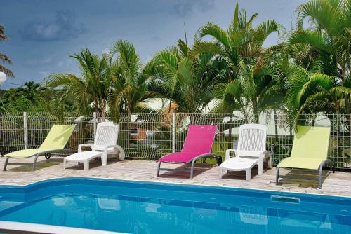 a group of chairs and a swimming pool at LE VILLAGE DE CANADA in Faup