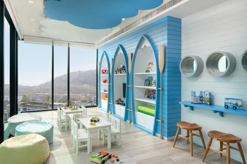 a room with surfboards on the wall at Holiday Inn & Suites Siracha Laemchabang by IHG in Si Racha