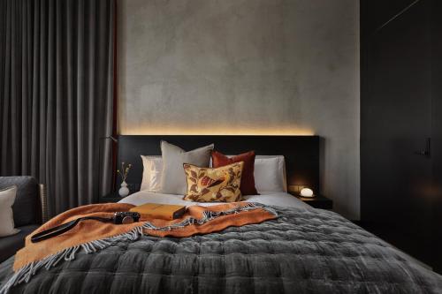 a bedroom with a large bed with pillows at Hotel Fitzroy curated by Fable in Auckland