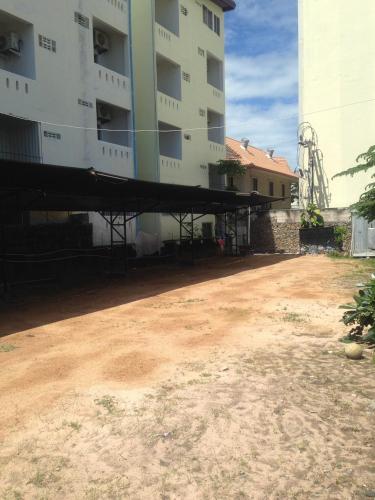 an empty parking lot in front of a building at Baan Talay in Pattaya South