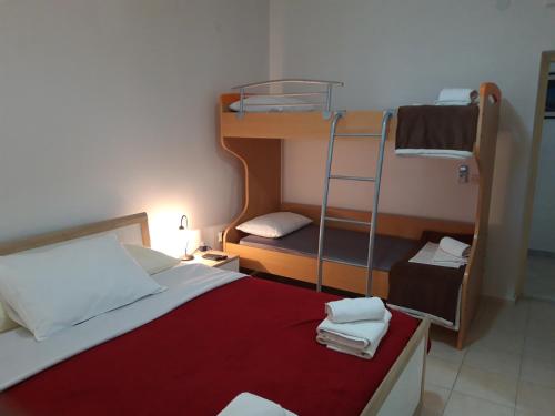 a small room with a bed and bunk beds at Sasa Apartments Kastel Stafilic Croatia in Kaštela