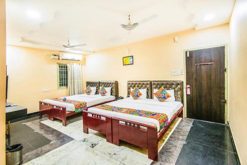 a bedroom with two beds in a room at Royal Palace Marina in Chennai