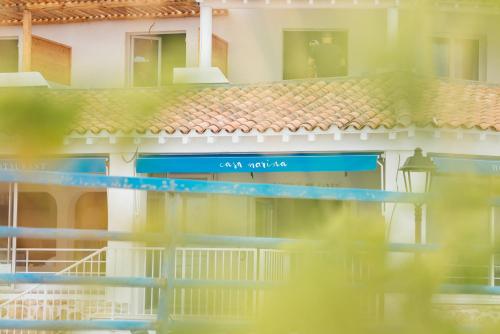 a building with a sign on the side of it at Hôtel Casa Marina in Saintes-Maries-de-la-Mer