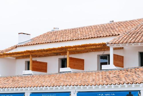 a house with red tile roofs at Hôtel Casa Marina in Saintes-Maries-de-la-Mer