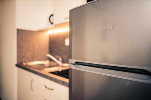 a kitchen with a stainless steel stove and a sink at Penzion vinařství Mikulica in Velké Pavlovice
