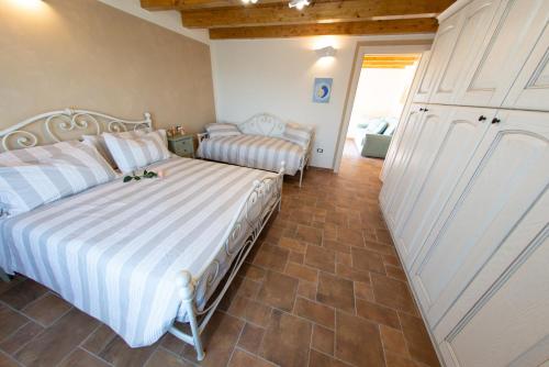 a bedroom with two beds and a sliding door at La Beppa - Casa Vacanza in Pontremoli