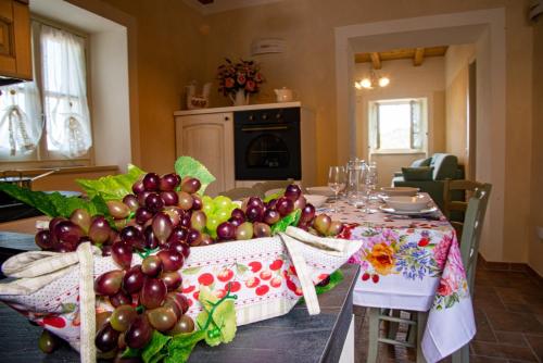 a table with a bunch of grapes on it at La Beppa - Casa Vacanza in Pontremoli