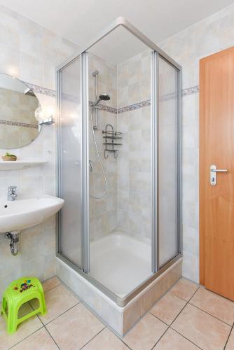 a shower with a glass door in a bathroom at Ferienhaus Pia in Bensersiel