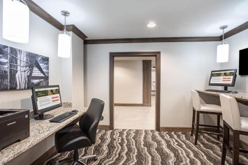 an office with a desk with a computer and chairs at Staybridge Suites Denver International Airport by IHG in Denver