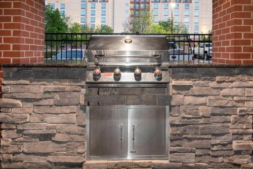 a stone kitchen with a stove in a brick wall at Staybridge Suites Denver International Airport by IHG in Denver