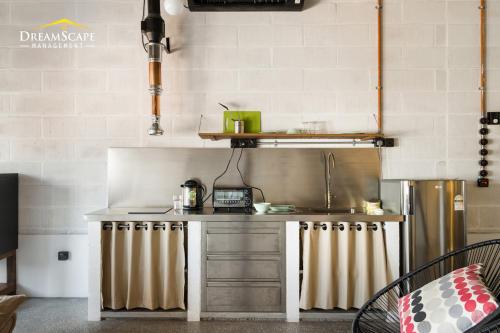 a kitchen with a sink and a counter top at Belakang KongHeng By DreamScape in Ipoh