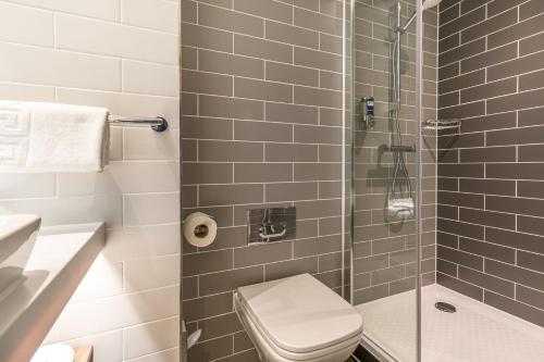 a bathroom with a shower with a toilet and a sink at Holiday Inn Express - Bodmin - Victoria Junction by IHG in Bodmin