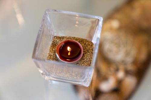 a small candle in a glass container with spices at Blue Boutique Apts in Amoudara Herakliou