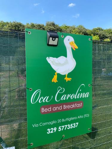 a sign for a dog park with a duck on it at Oca Carolina in Buttigliera Alta