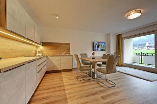 a kitchen and dining room with a table and chairs at Apartment Jäger in Ried im Zillertal