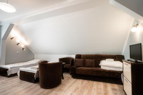 a living room with a couch and a bed at Pablo in Niechorze