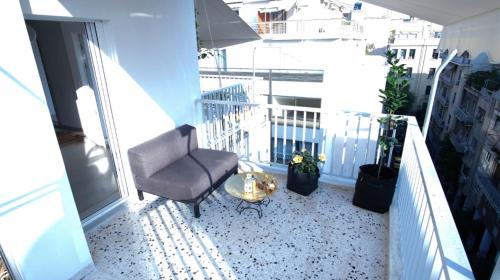 a balcony with a chair and a table at Heart of Athens!! central nice rooftop flat in Athens