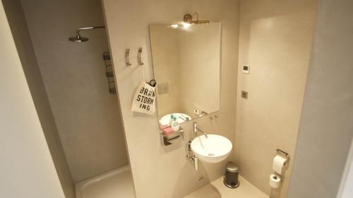a small bathroom with a sink and a mirror at Heart of Athens!! central nice rooftop flat in Athens