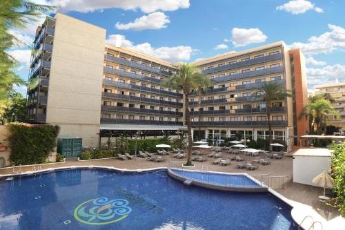 a hotel with a large swimming pool in front of a building at Eurosalou & Spa in Salou