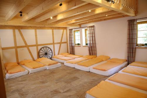 a room with a row of beds in it at Erlebnisgastronomie Lochmuhle in Eigeltingen