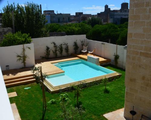 a swimming pool in the yard of a house at Distilia Dimora Salentina in San Cesario di Lecce