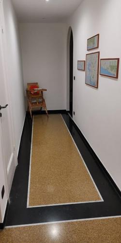 an empty room with a hallway with a table at B&B Gaslini & Mare (anche con uso cucina) in Genova