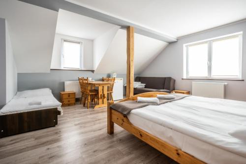 a bedroom with a bed and a table and chairs at Pablo in Niechorze