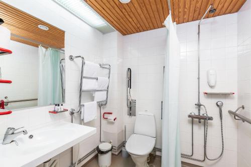 a white bathroom with a sink and a toilet at Finlandia Hotel Imatran Kylpylä Spa in Imatra