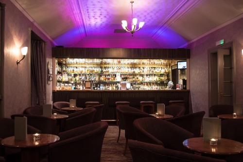 un bar avec éclairage violet dans un restaurant dans l'établissement Laichmoray Hotel, à Elgin