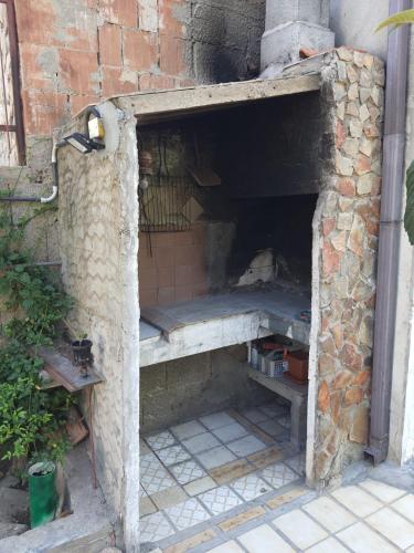 a brick oven with a bench inside of it at Dwelling Zara in Solèminis